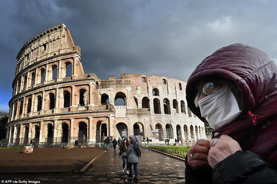 25668576-8087171-A_man_wearing_a_protective_mask_passes_by_the_Coliseum_in_Rome_t-a-7_1583653385104