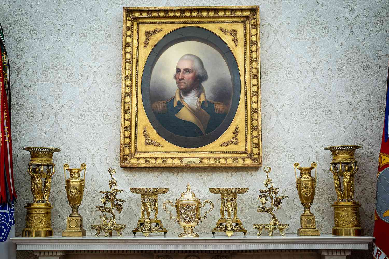 Gold-decorations-sit-on-a-fireplace-mantle-as-President-Donald-J-Trump-speaks-in-the-Oval-Office-042125-dd83c1147615491a971edadfdc933acb